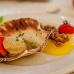 Seafood side dish. Scallop, polenta, shrimp, tomato. Italian dish.