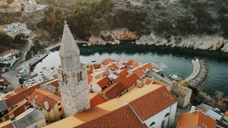 Staying Connected in Dubrovnik: SIM Cards & eSIM Tips โ Travel Guide to Dubrovnik 88 a large building with a tower by a body of water