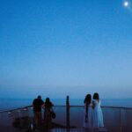 A group of people standing on top of a roof