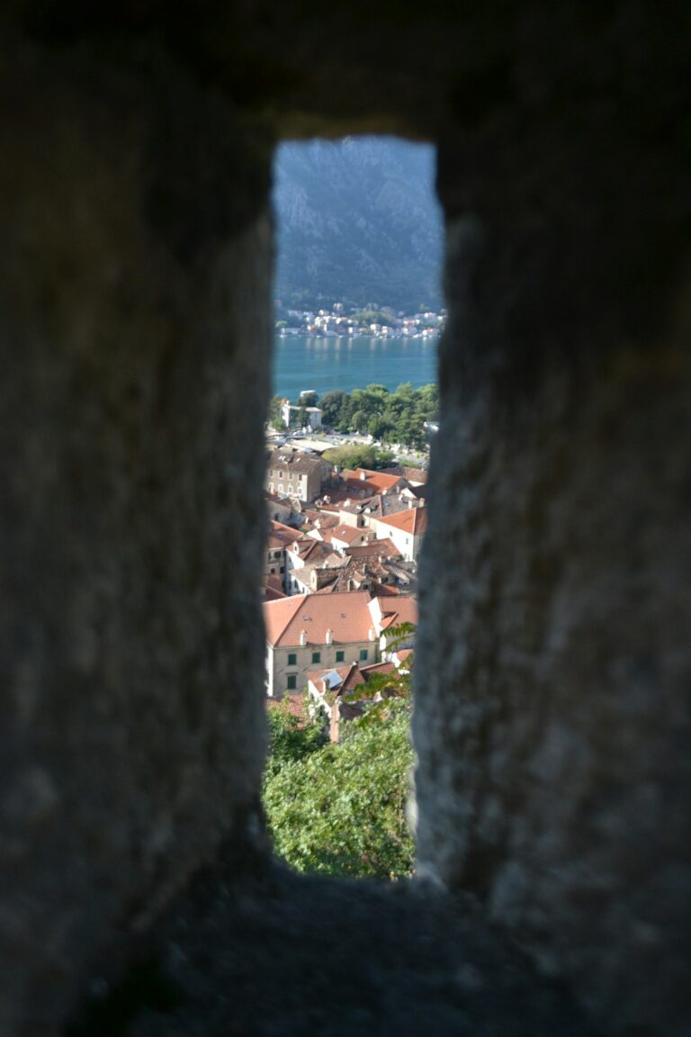 A view of a city through a hole in a wall